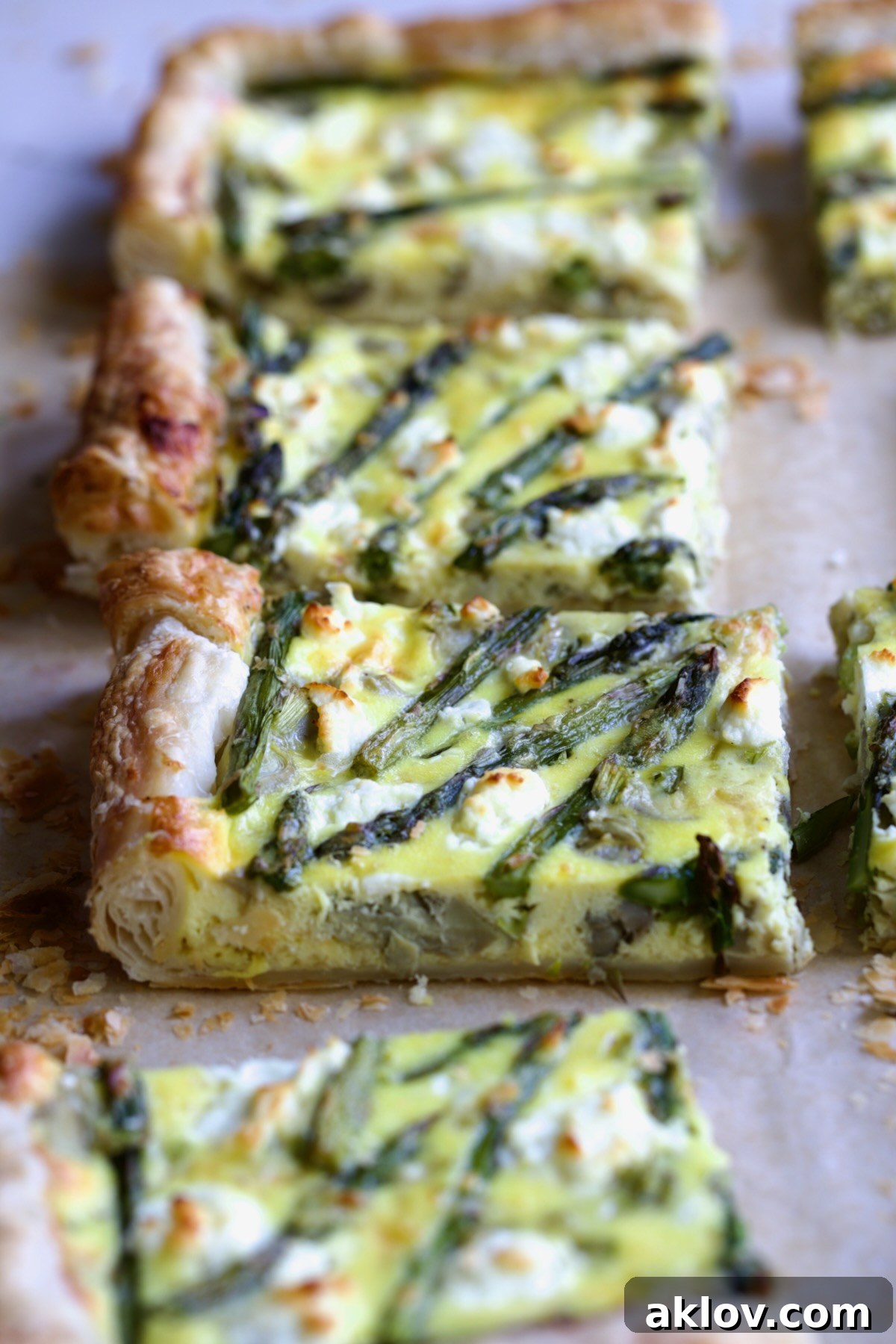 Four pieces of Puff Pastry Vegetable Tart with focus on one to expose layers of puff pastry.