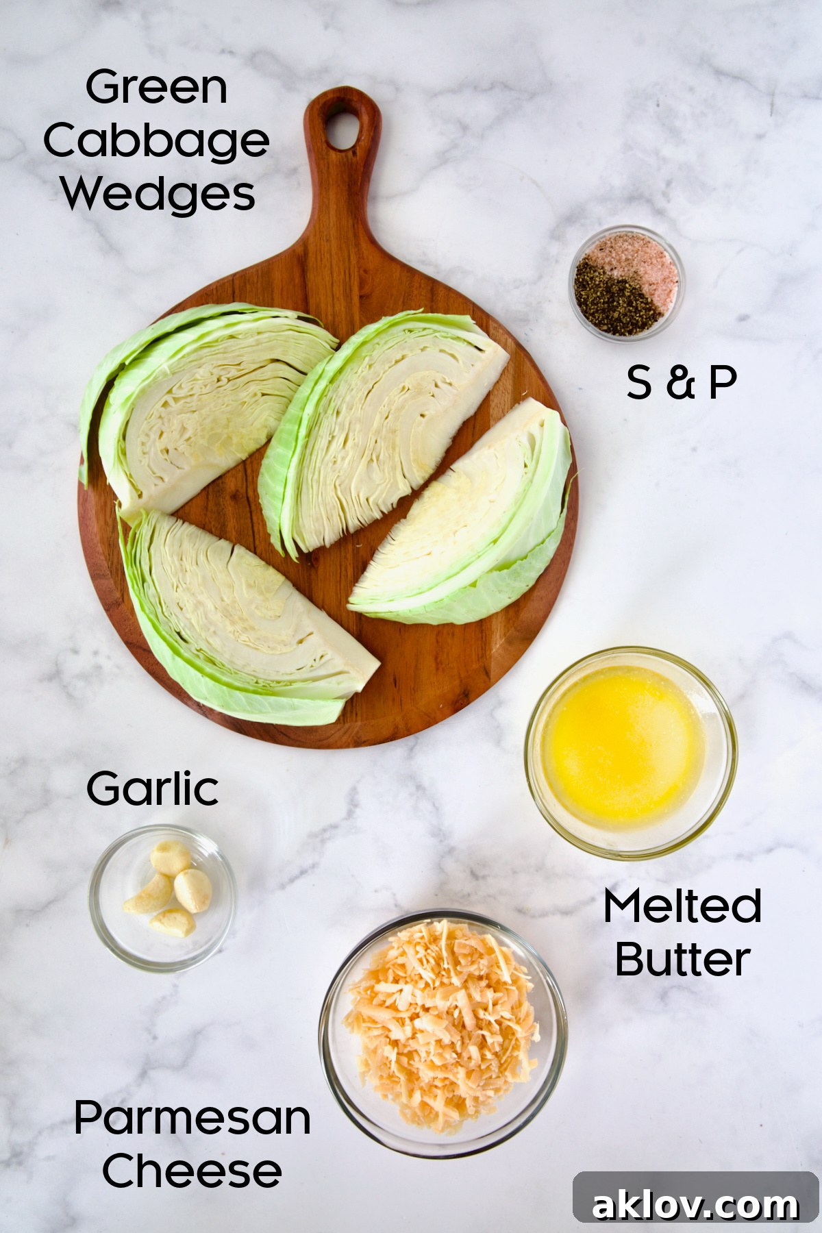 A collection of fresh ingredients for Baked Garlic Parmesan Cabbage Wedges, including cabbage, garlic, butter, and Parmesan cheese, in glass bowls.