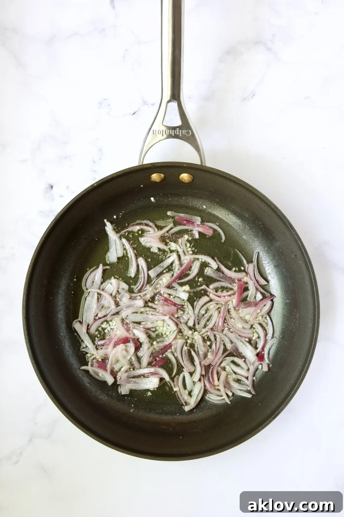 Cooked onions and garlic gently sizzling in a skillet.