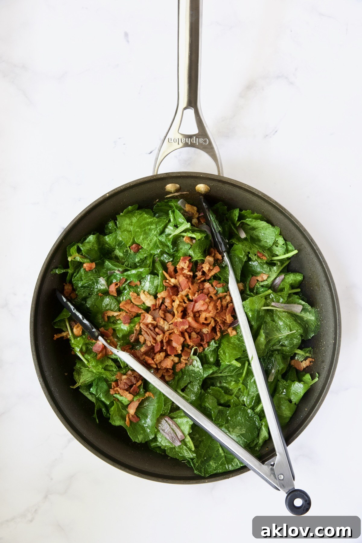 Slightly wilted radish greens, now mixed with crispy bacon bits, ready for serving in the same skillet they were dressed in.