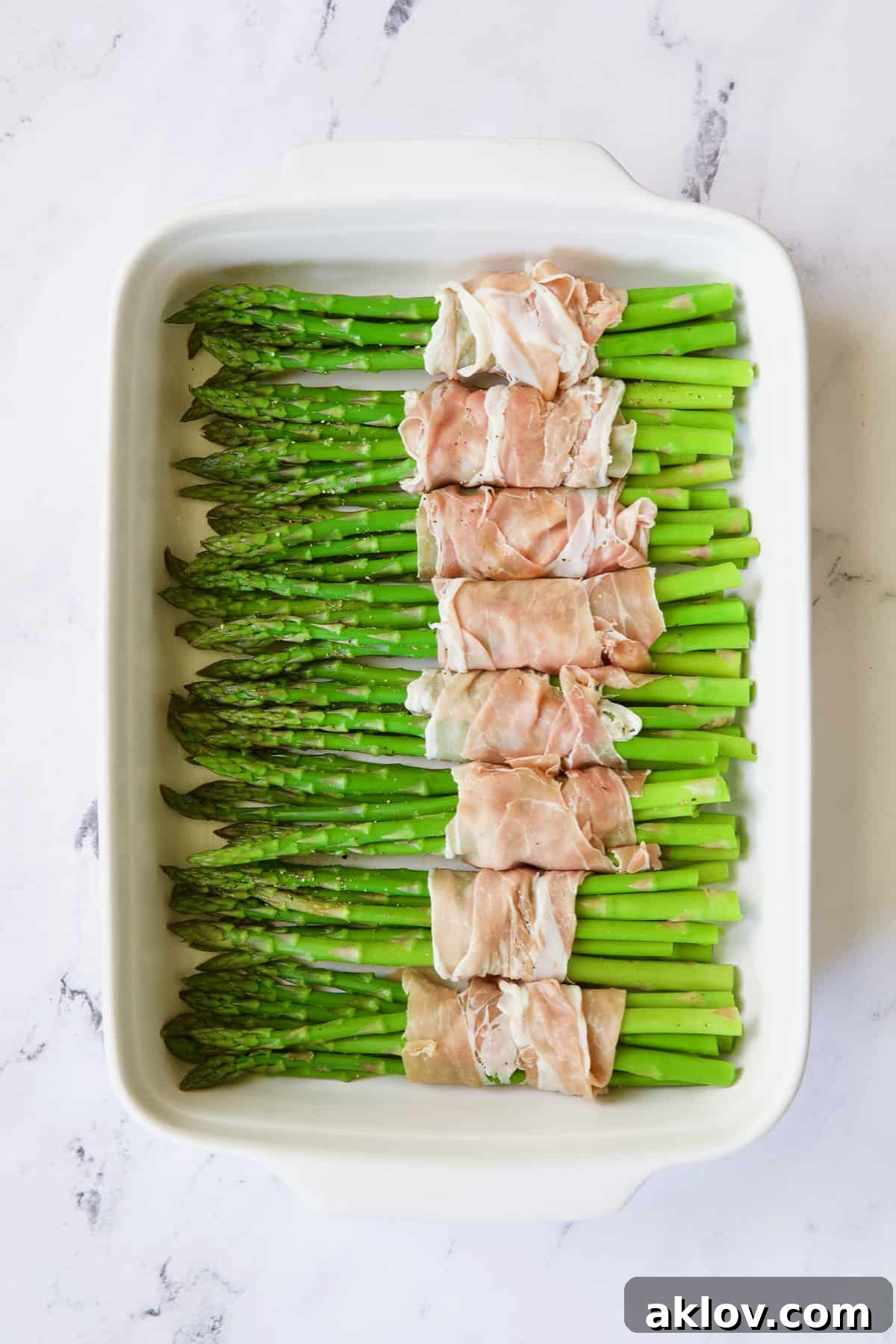 Photo of bundles of asparagus wrapped in prosciutto.