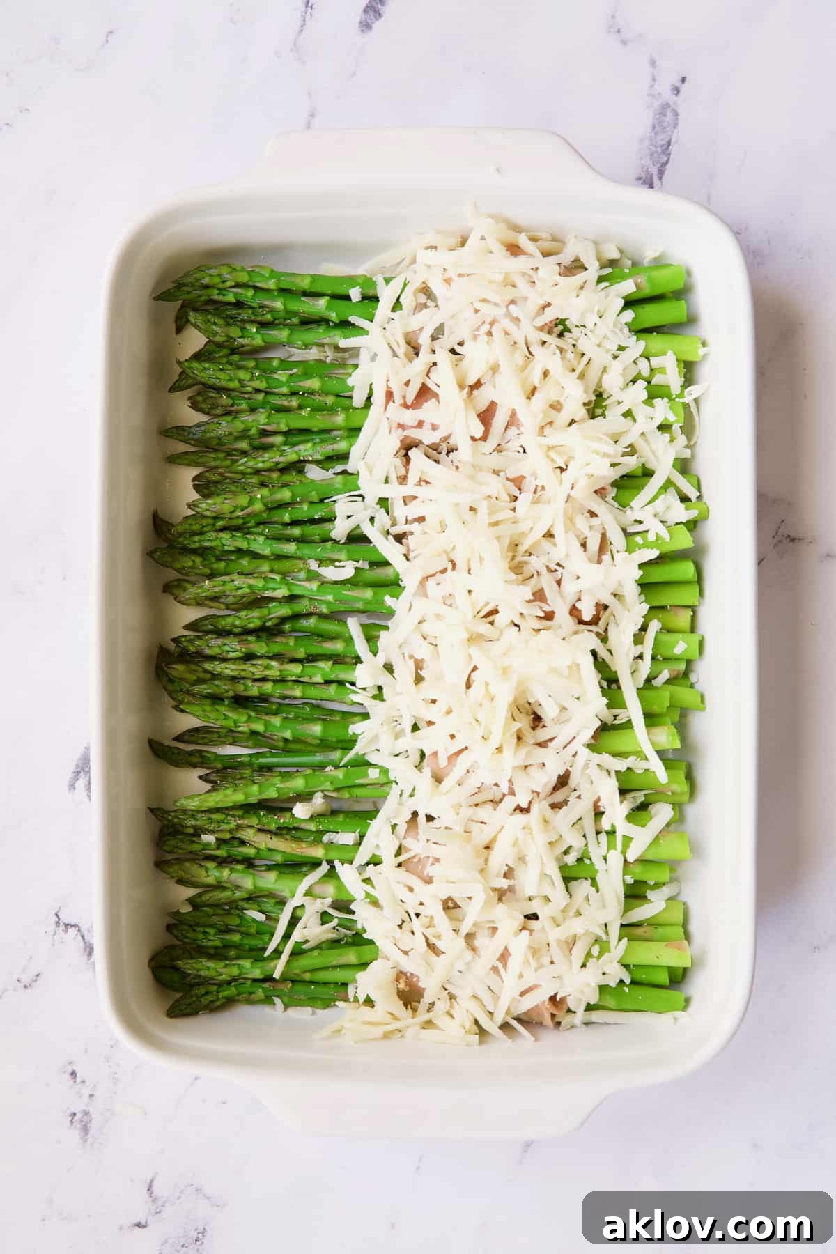 Photo of asparagus covered with Gruyere cheese.