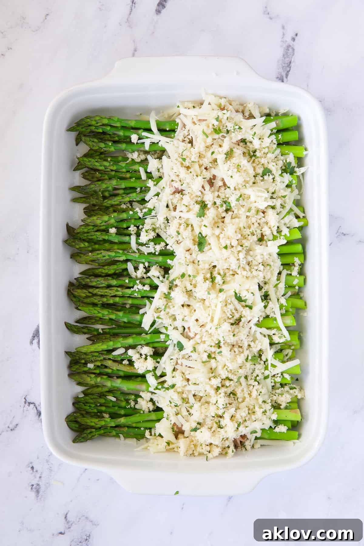 Photo of asparagus topped with cheese and breadcrumb topping.