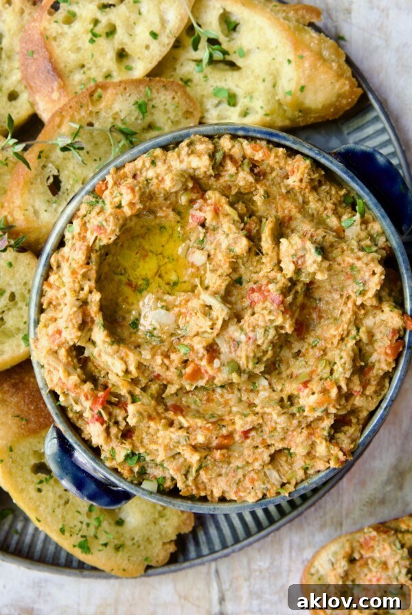 Artichoke Tapenade served elegantly in a blue bowl, inviting guests to savor its rich flavors.