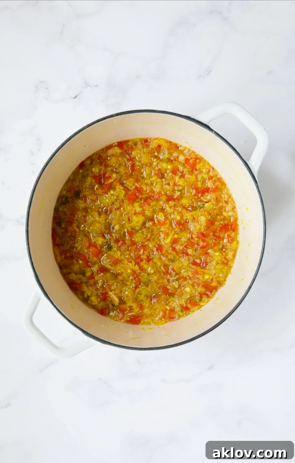 Fiery Ramp Relish 10 Cooked ramp relish ingredients in a white Dutch oven, vibrant and ready.