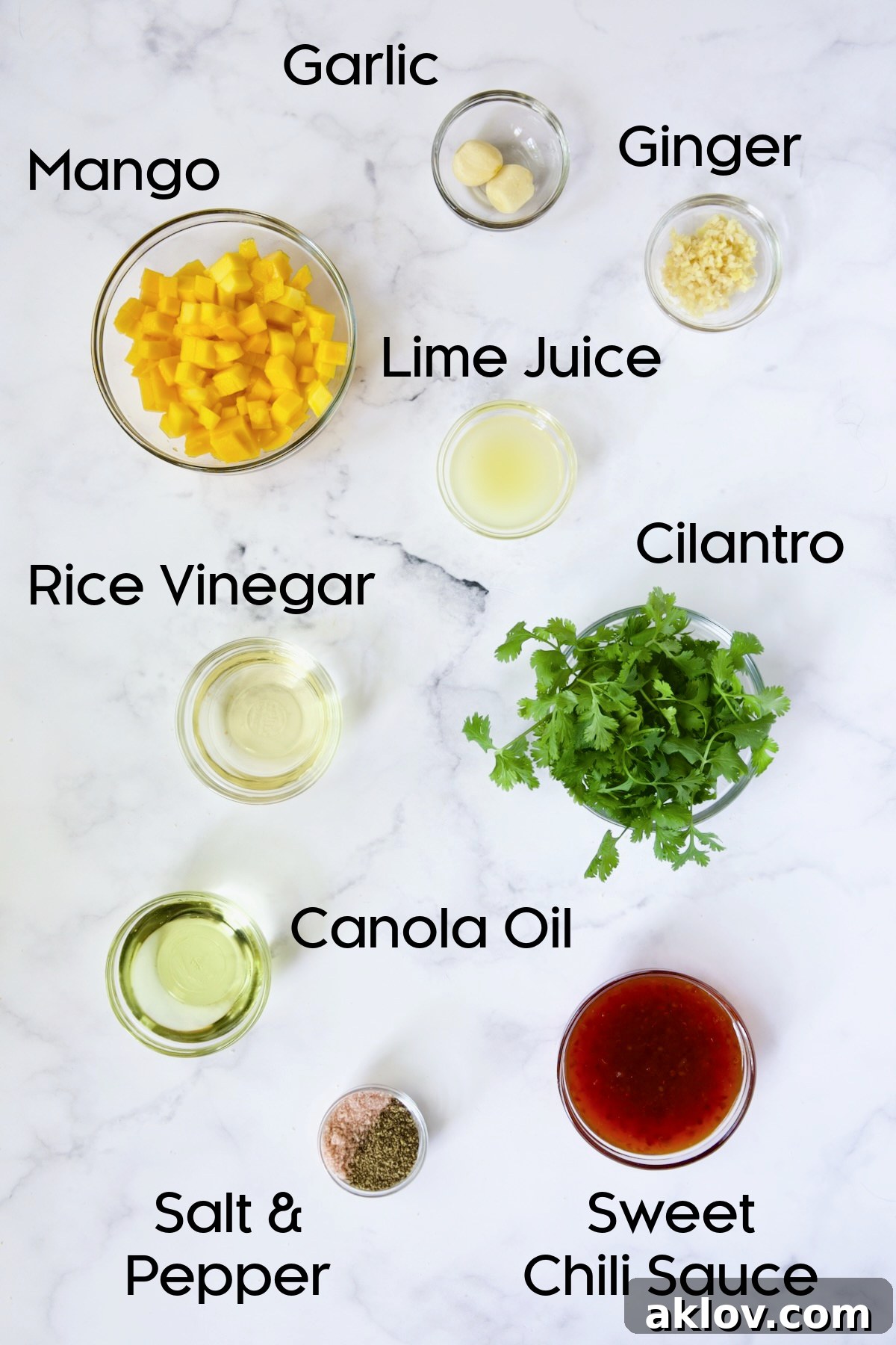 Glass bowls displaying the liquid ingredients for the sweet chili vinaigrette: chopped cilantro, sweet chili sauce, rice vinegar, and canola oil, ready to be combined.