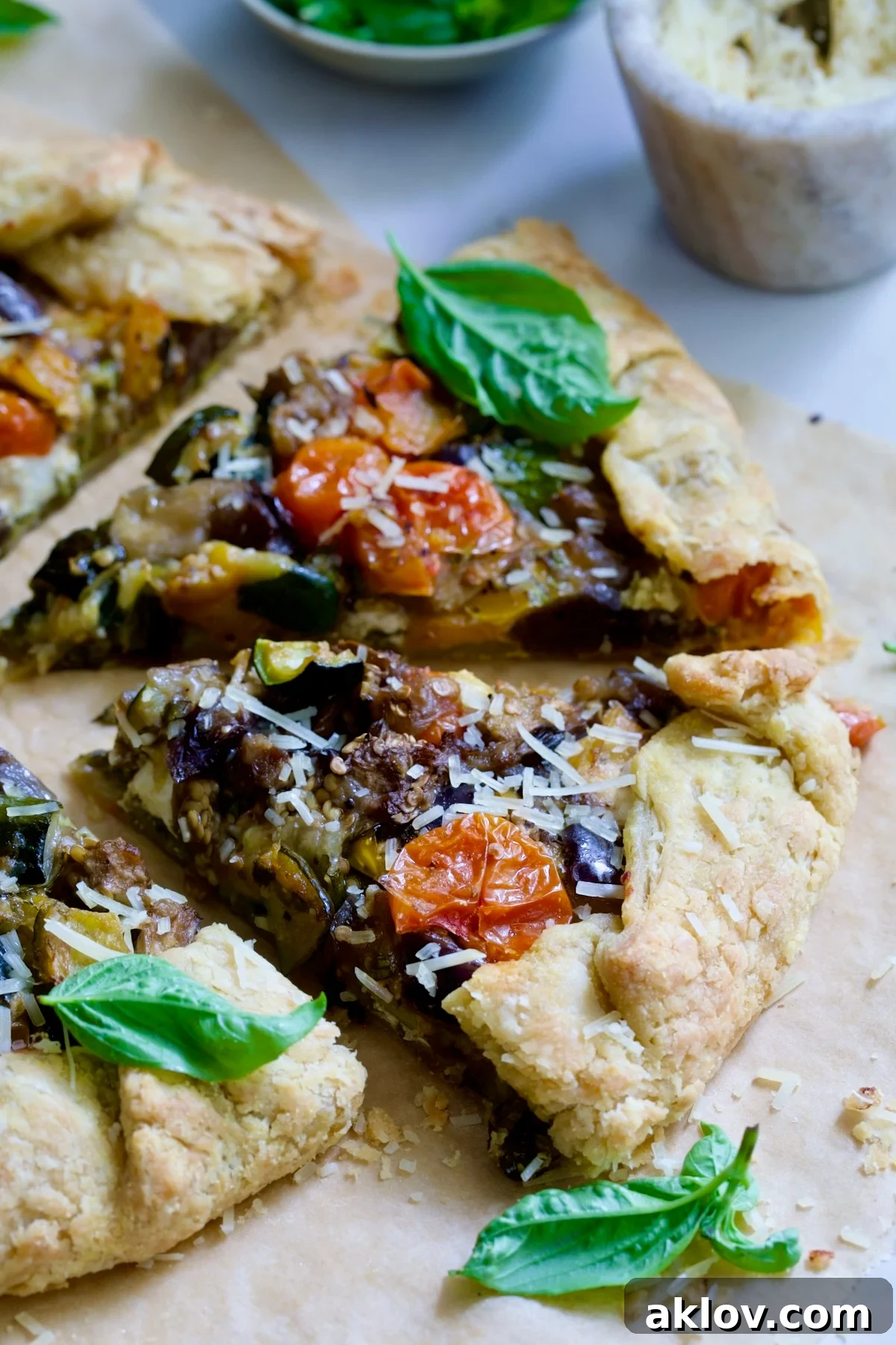 Two generous wedges of Mediterranean Vegetable Galette, beautifully showcasing the colorful roasted filling and golden crust.
