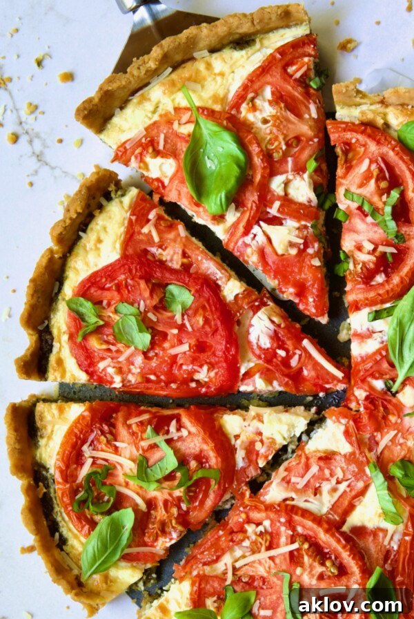 Tomato Tart with Ricotta and Cheese sliced into wedges and garnished with fresh basil leaves.
