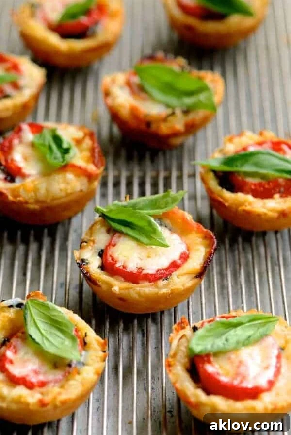 Mini Southern Tomato Pies on cooling rack garnished with fresh basil.
