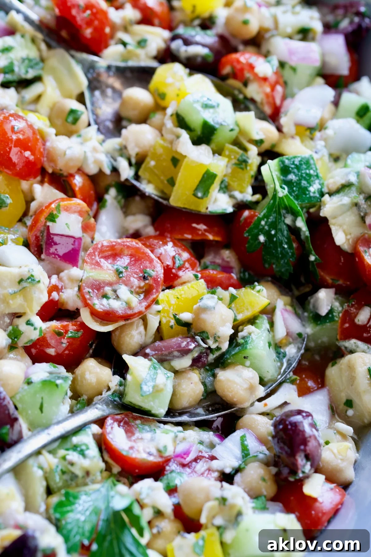 Two spoons scooping up the salad.