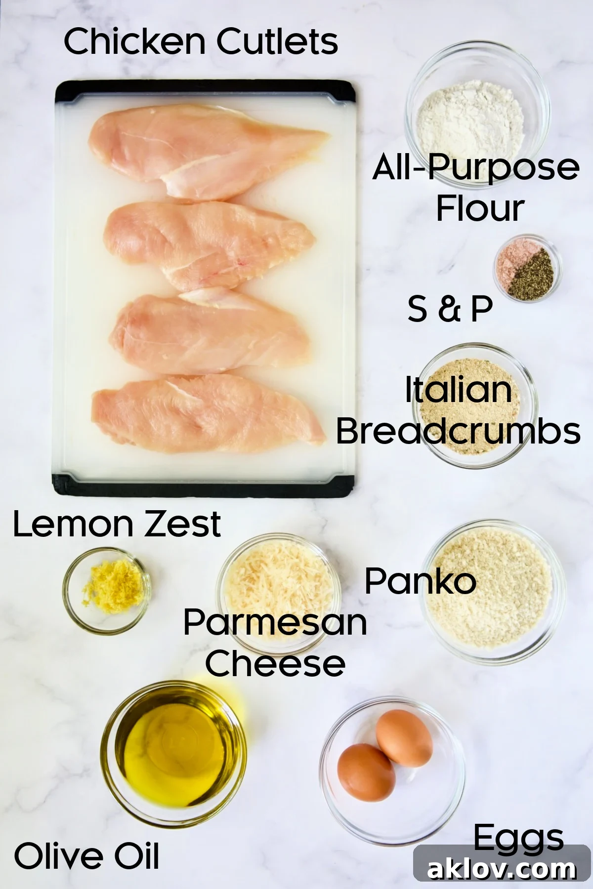 Golden Crispy Milanese 4 Glass bowls showcasing ingredients for Chicken Milanese: flour, eggs, breadcrumbs, Parmesan, and lemon.