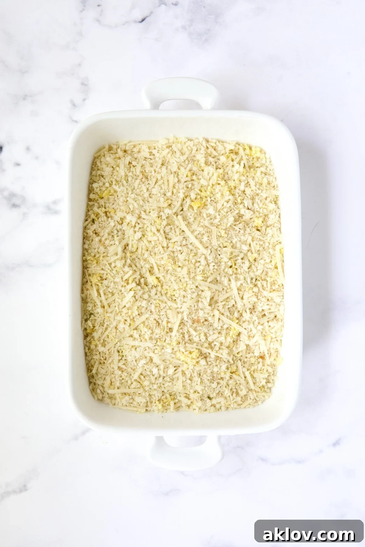 Golden Crispy Milanese 10 A white rectangular dish filled with a coarse breadcrumb combination of panko, Italian breadcrumbs, Parmesan cheese, and lemon zest.