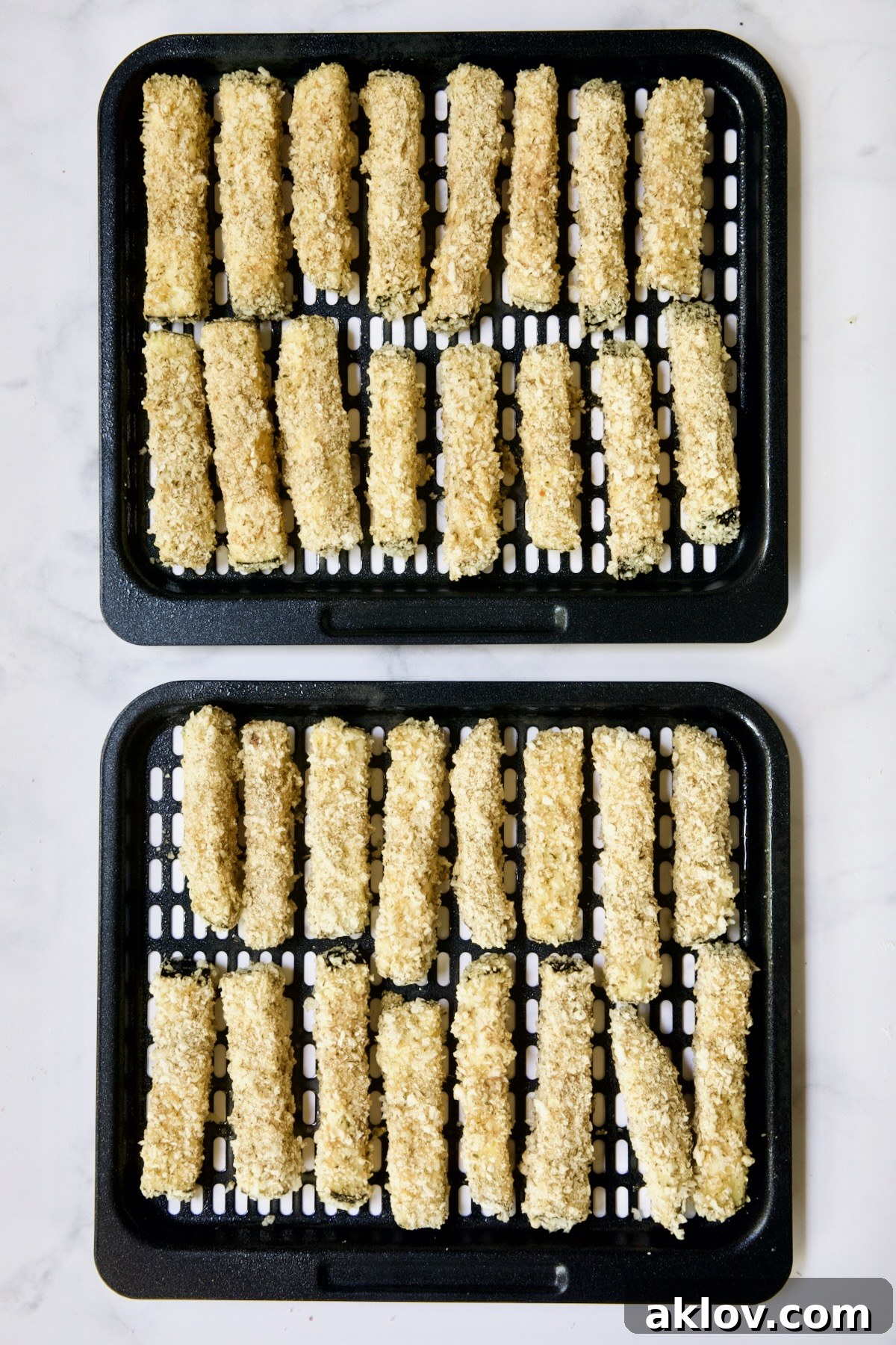 Two trays of eggplant fries before being fried in air fryer.