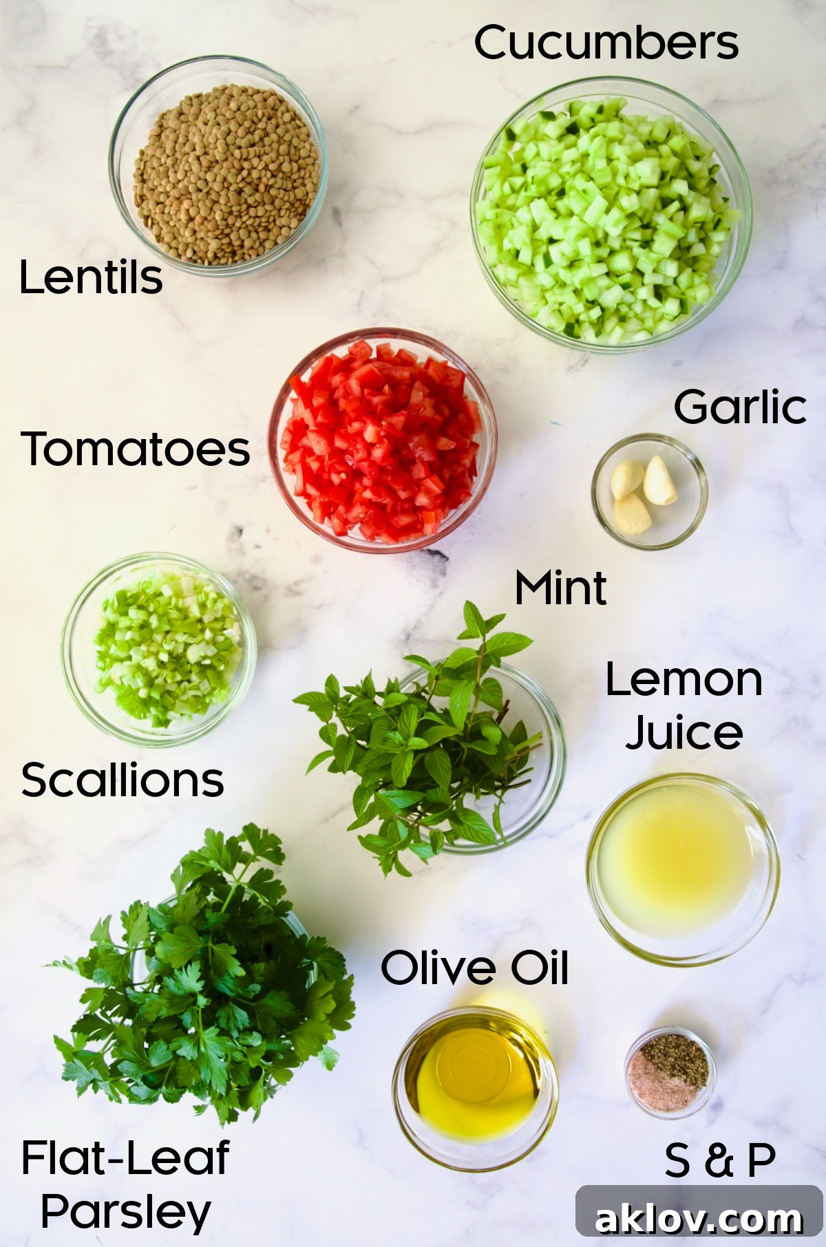 Ingredients for Lentil Tabbouleh in glass bowls on marble countertop.