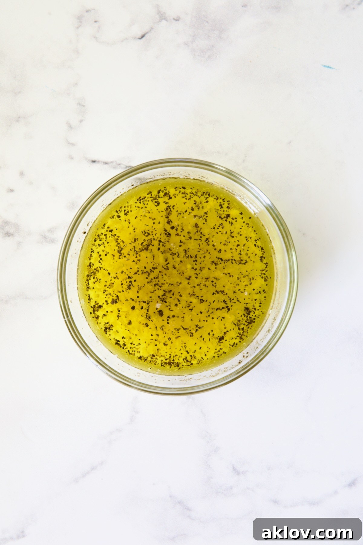 Dressing for tabbouleh in glass bowl.