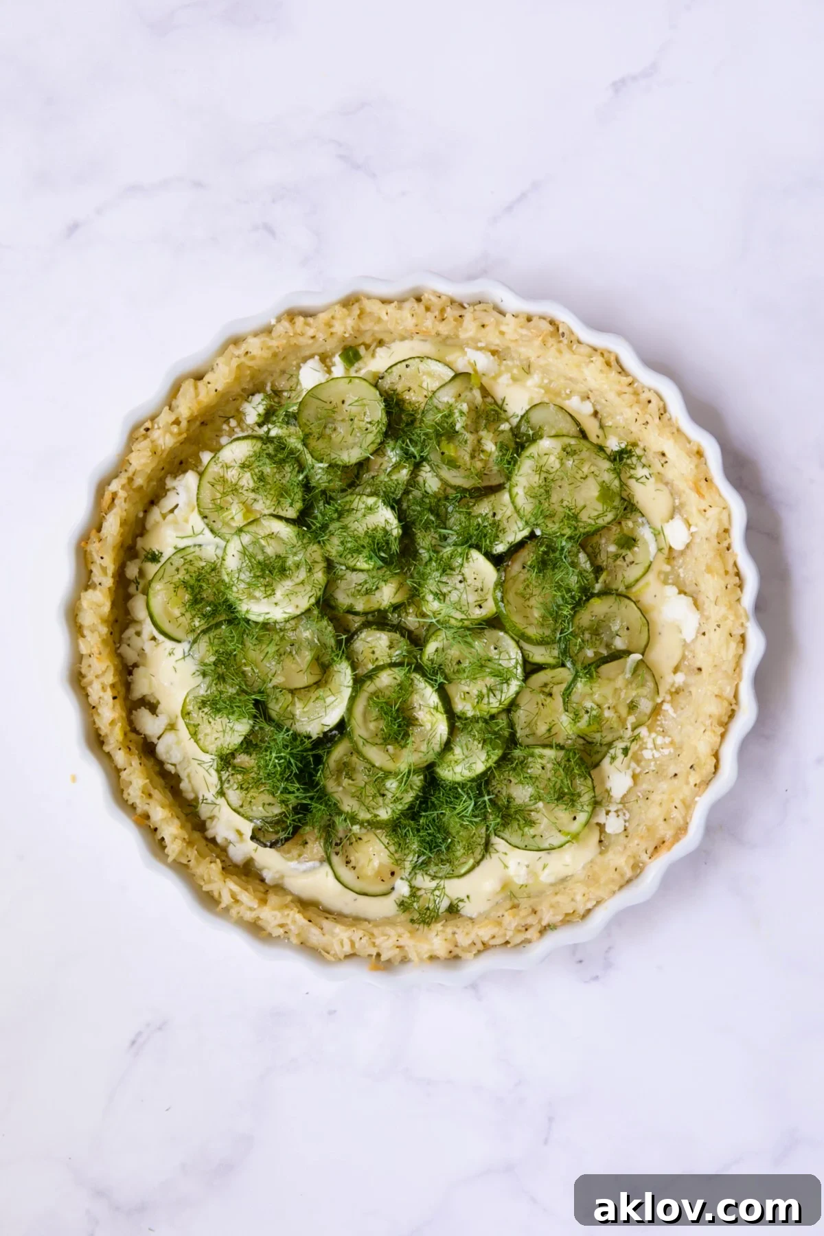 Zucchini in pie with dill scattered over the top.