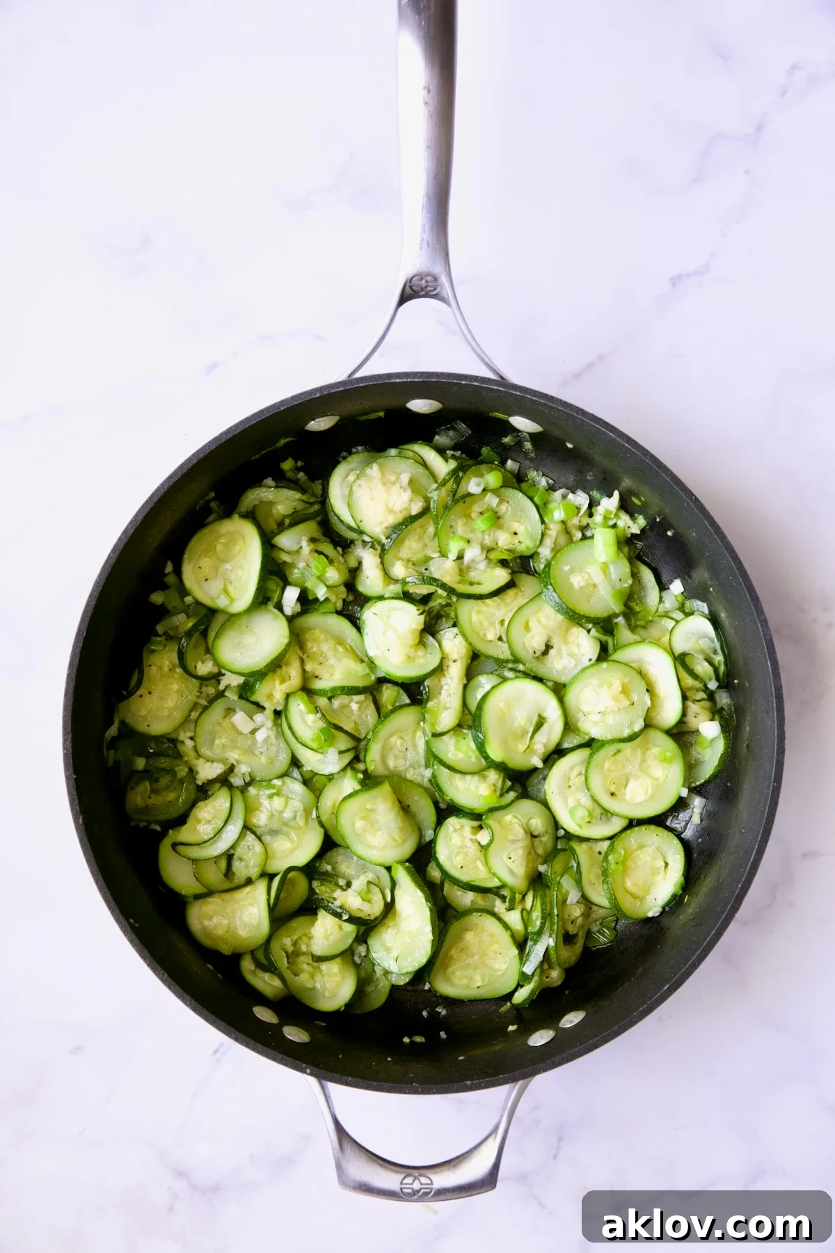 Cooked zucchini slices in nonstick skillet.