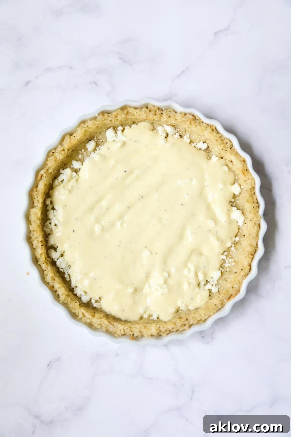 Half the ricotta custard spread over feta cheese in pie crust.