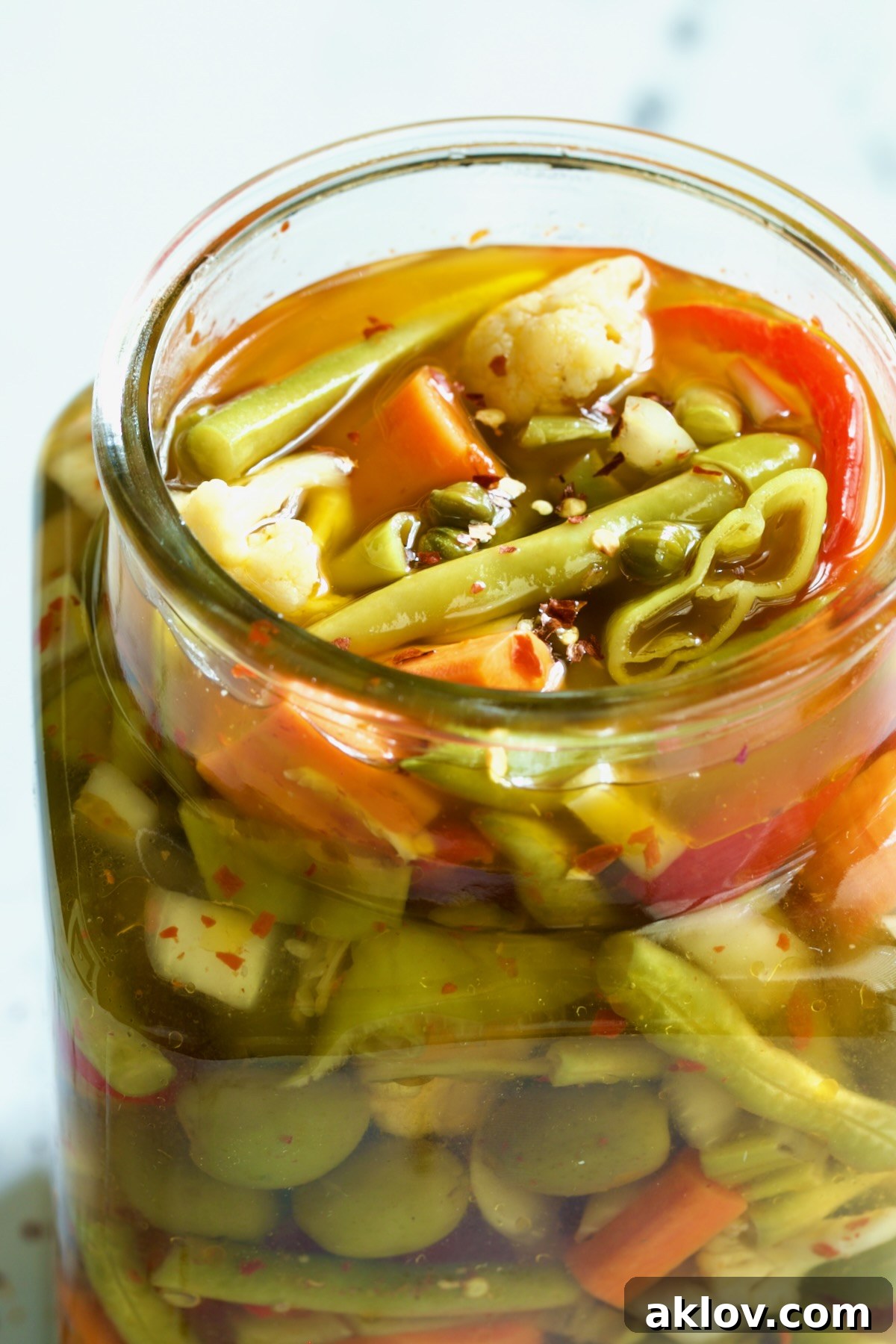 The Giardiniera in a glass jar, with the olive oil added and stirred in, ready for refrigeration and flavor development.