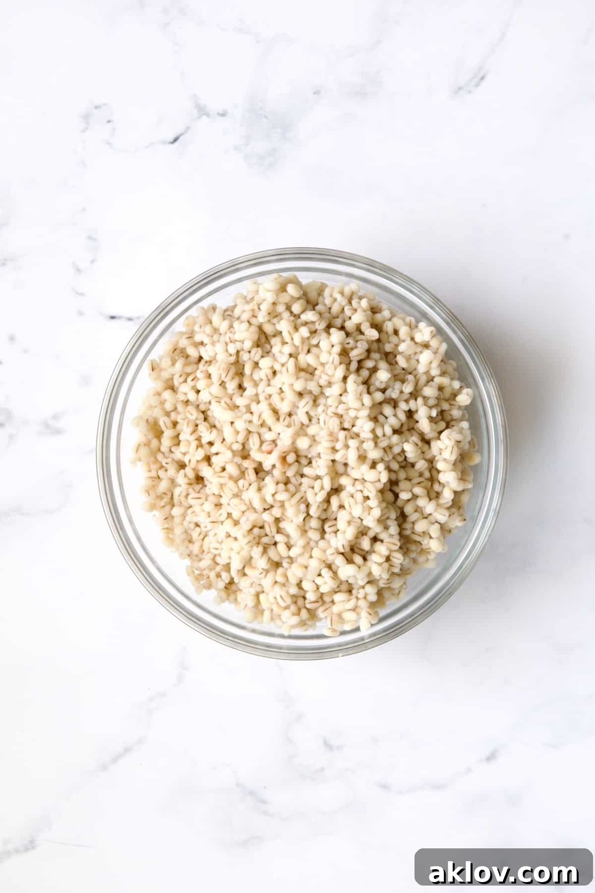Bowl of cooked barley in glass bowl.