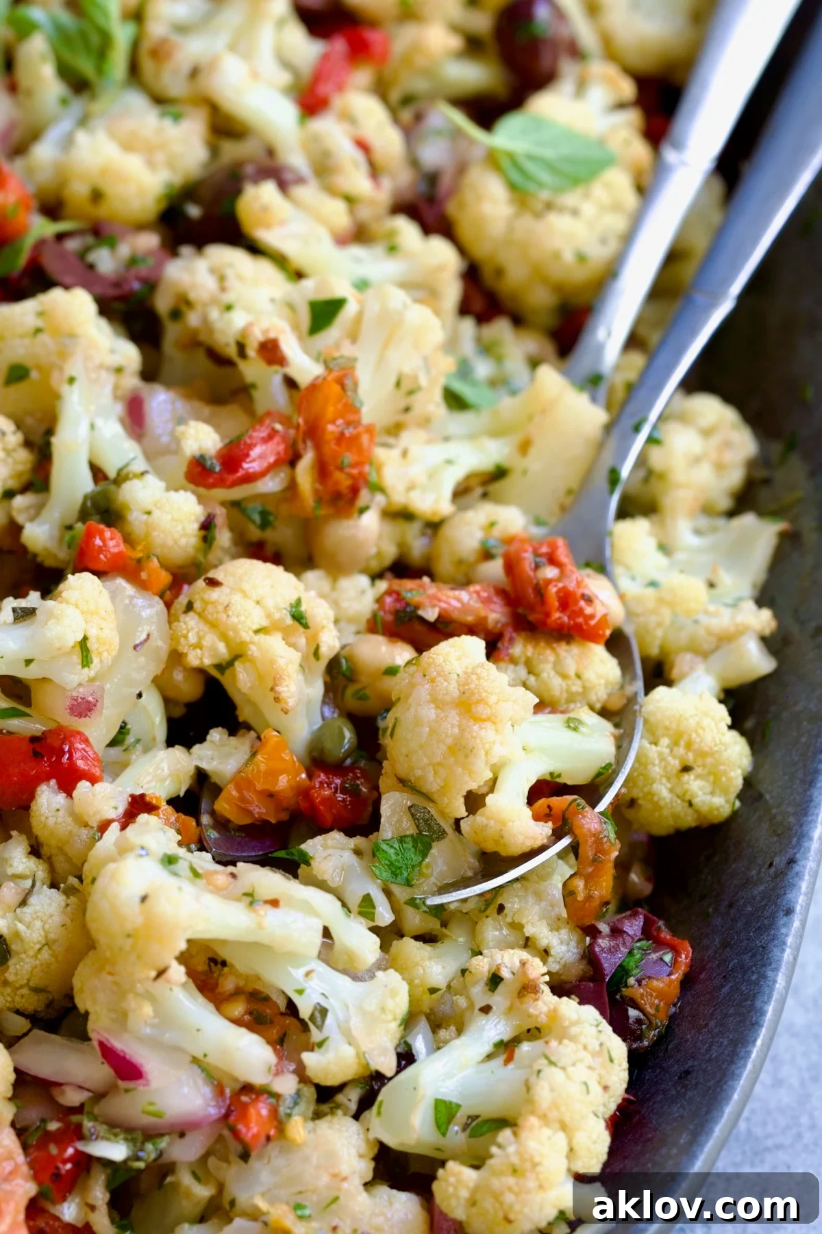 Another enticing view of the Roasted Cauliflower Salad, served on a gray speckled platter, inviting you to try a bite.