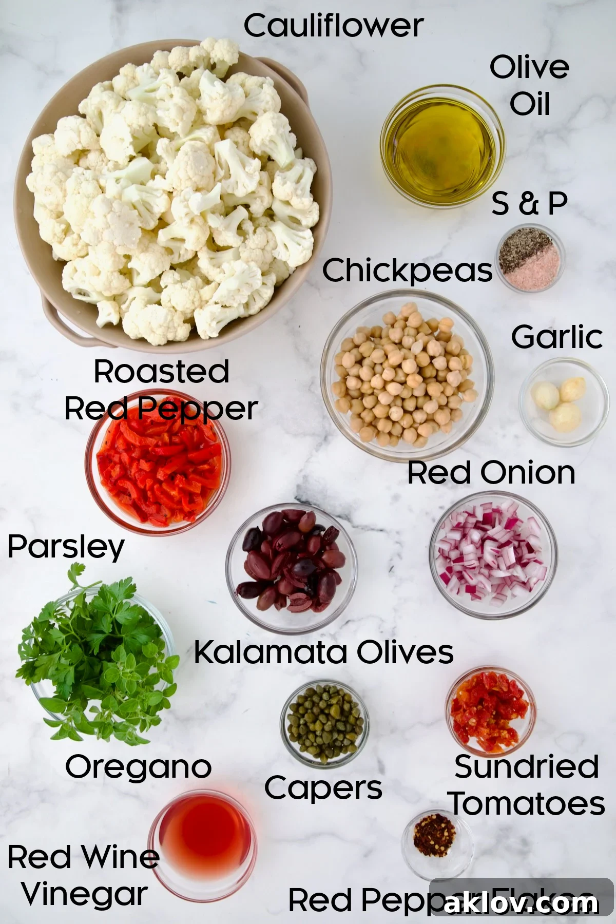 All the fresh and pantry ingredients laid out in glass bowls, ready for preparing the Roasted Cauliflower Salad.
