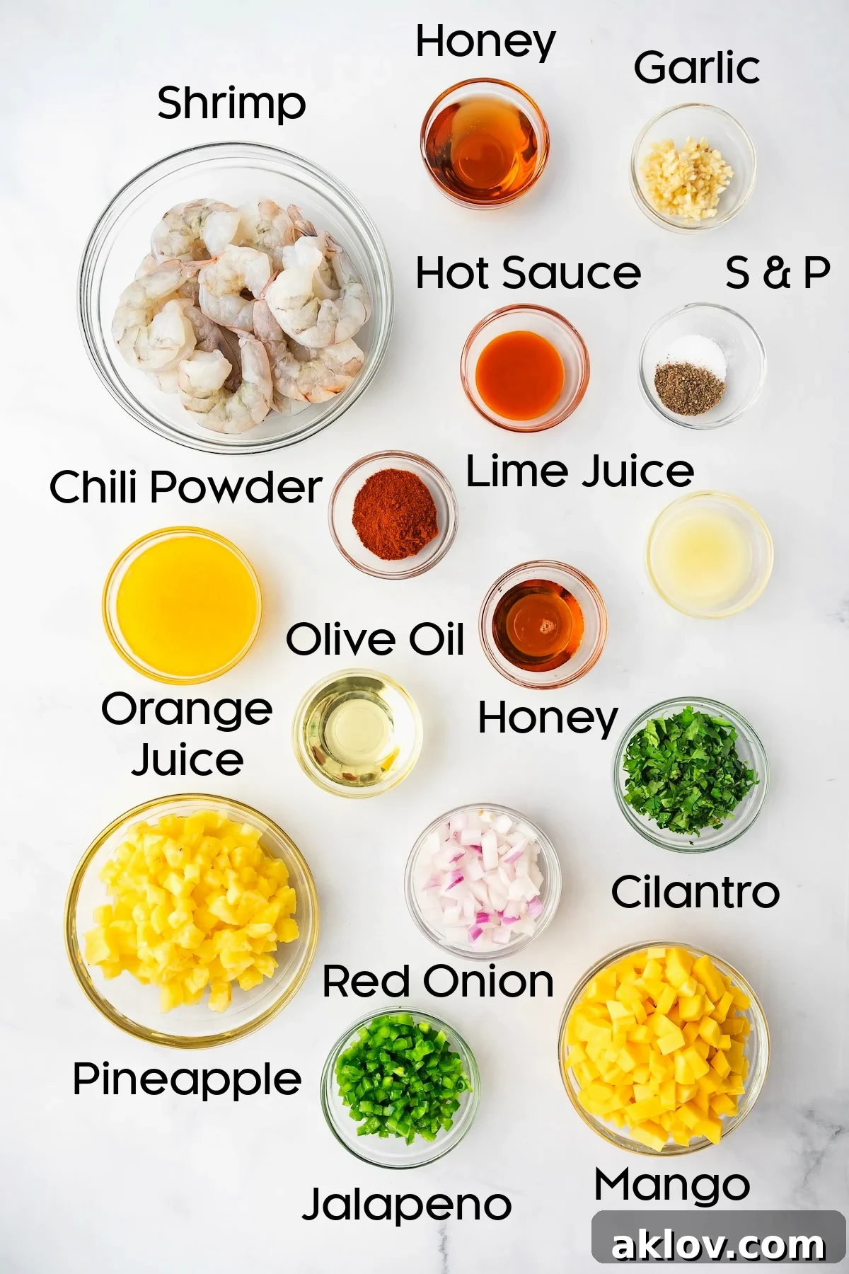 A beautiful assortment of fresh ingredients for Grilled Shrimp Skewers and Pineapple Mango Salsa, neatly arranged in glass bowls.