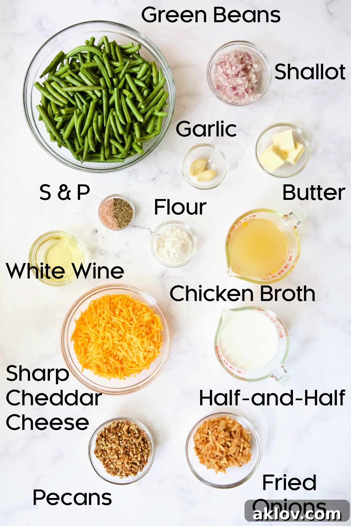Irresistible Cheesy Green Bean Bake 4 Various ingredients for Cheesy Green Bean Casserole displayed in clear glass bowls, including green beans, cheese, and shallots.