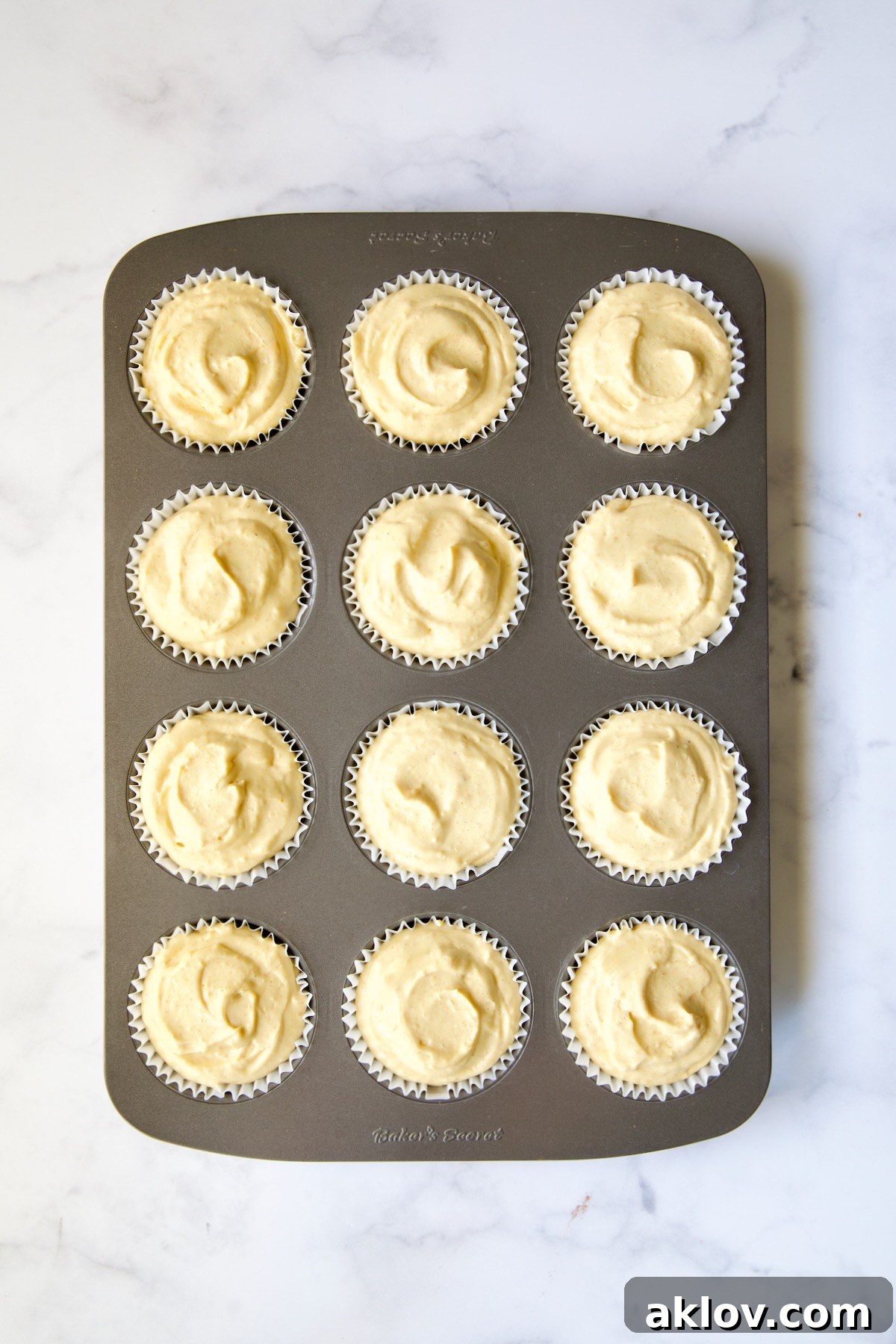 No-Bake Fall Pumpkin Cheesecake Bites 11 Muffin pan with cheesecake filling in each of the cups.