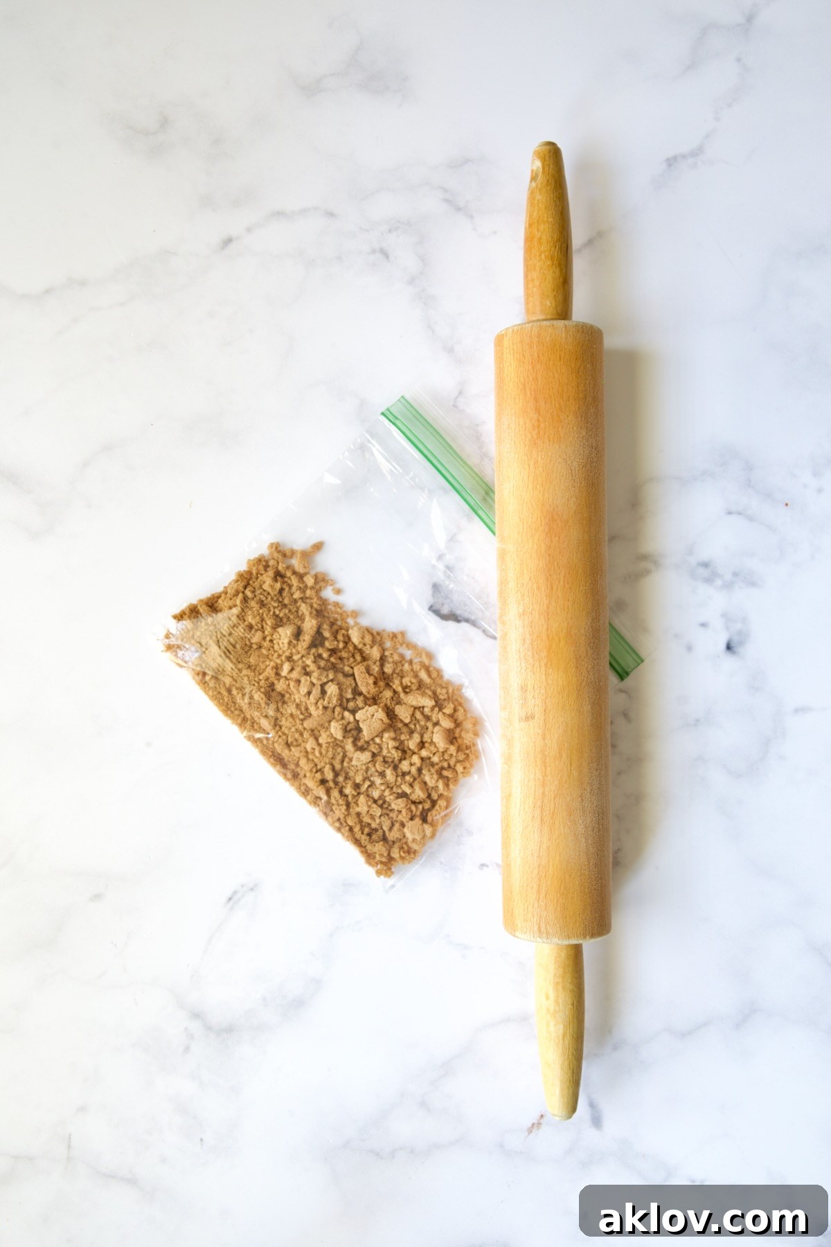 No-Bake Fall Pumpkin Cheesecake Bites 12 Crushed gingersnap cookies in a sandwich bag with a rolling pin nearby.