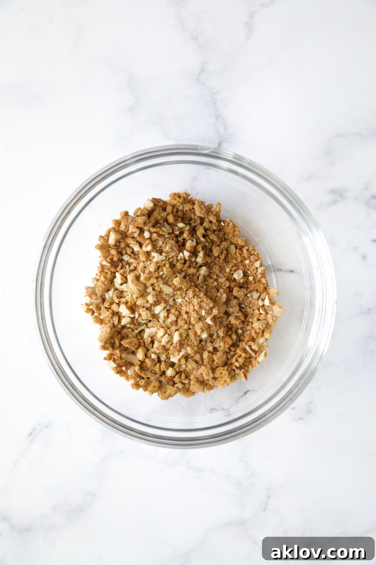No-Bake Fall Pumpkin Cheesecake Bites 13 Gingersnap and pecan topping mixture in a glass bowl.