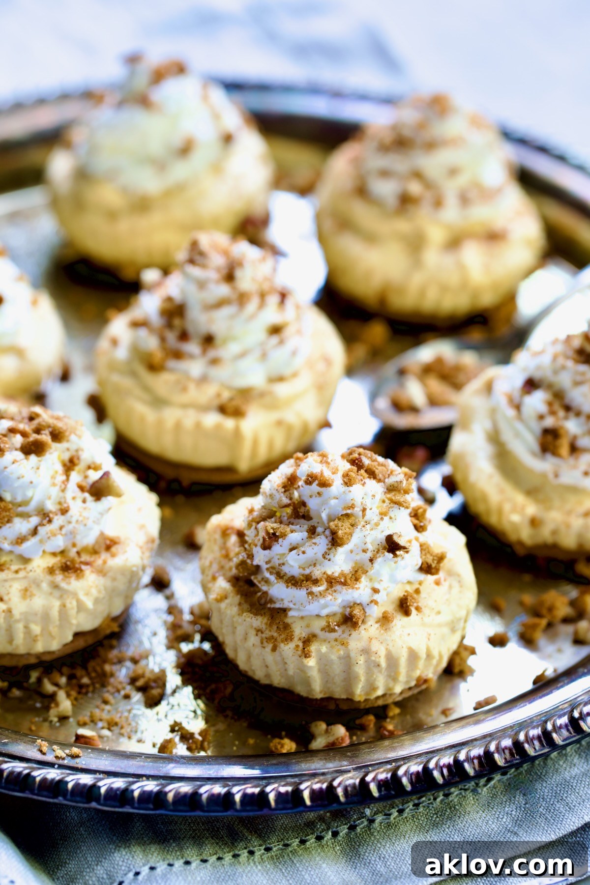 No-Bake Fall Pumpkin Cheesecake Bites 16 Seven Easy Mini No-Bake Pumpkin Cheesecakes on an antique silver platter, beautifully presented.