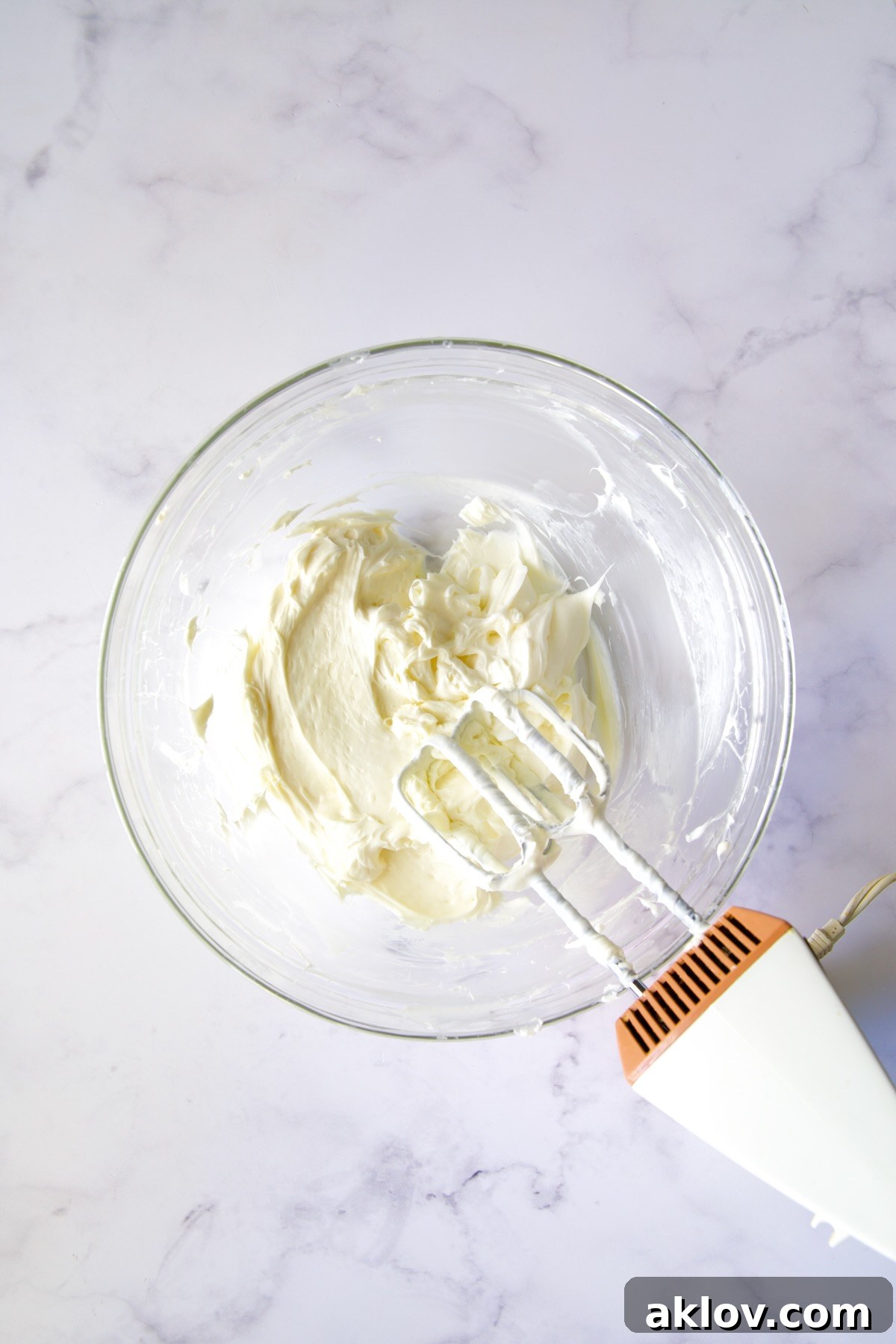 No-Bake Fall Pumpkin Cheesecake Bites 9 Cream cheese and powdered sugar blended to a smooth consistency in a glass bowl.