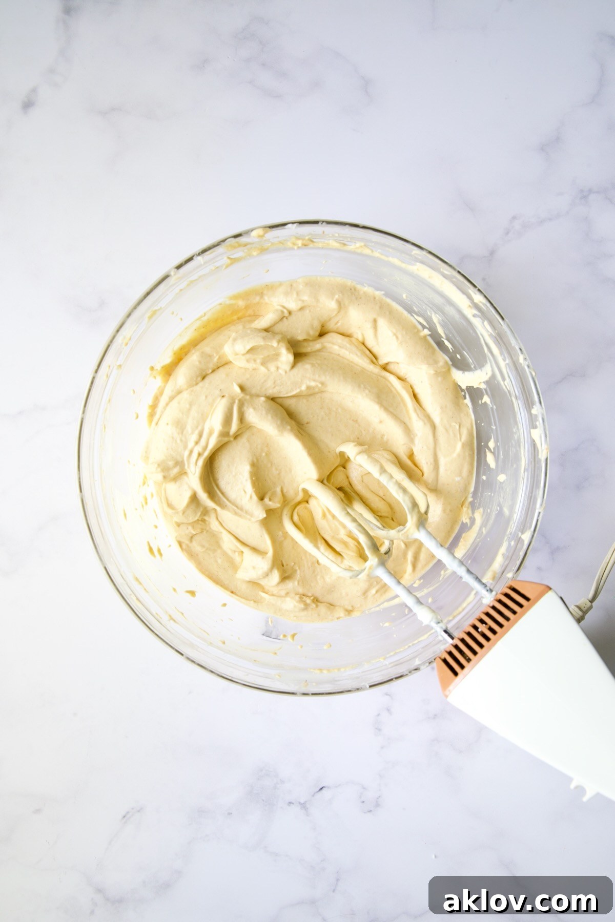 No-Bake Fall Pumpkin Cheesecake Bites 10 Pumpkin cheesecake filling in a glass bowl, light and fluffy.