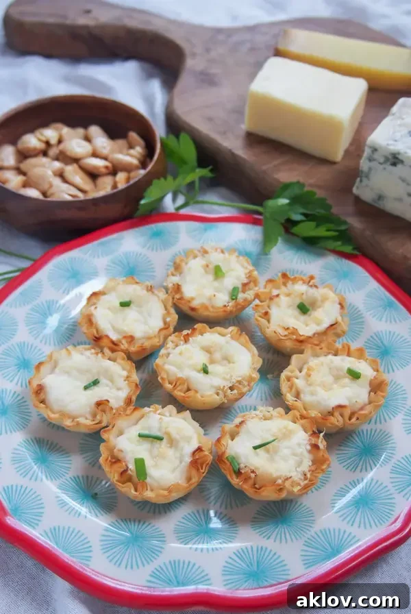 Eight Crab-Stuffed Phyllo Cups on blue plate with red rim.