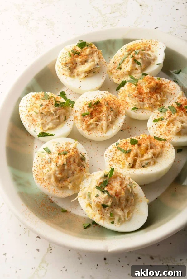 Crab Deviled Eggs on platter garnished with parsley.