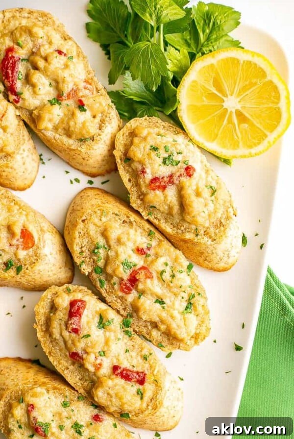 Crab Melts Appetizer on white platter garnished with parsley and lemon.