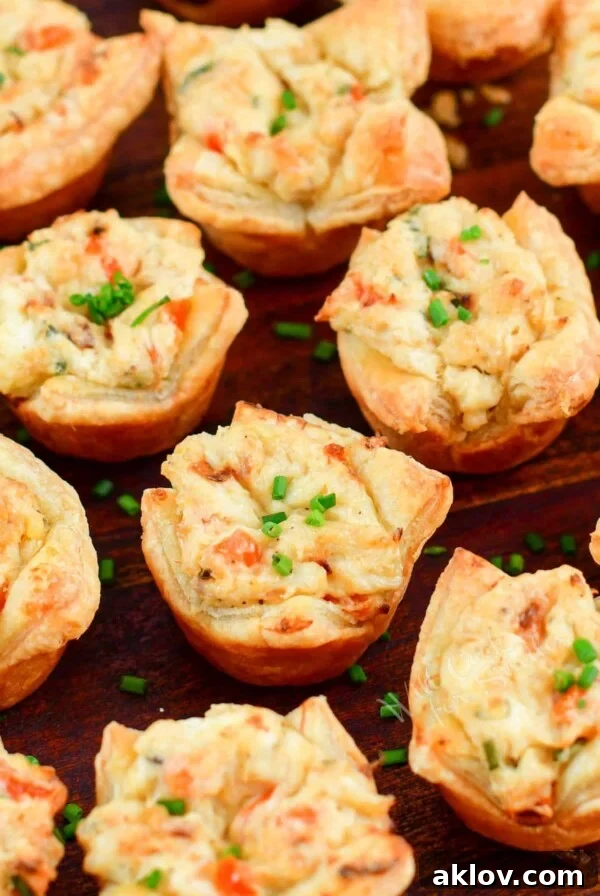 Crab Puffs on wood surface garnished with chopped chives.