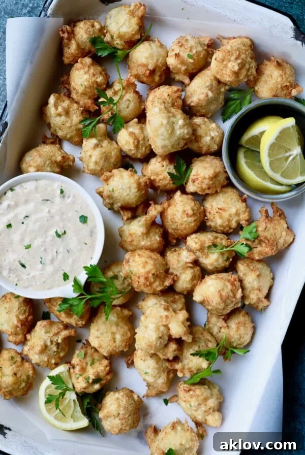 Crab and Artichoke Beignets with Jalapeno Remoulade - Overhead shot of beignets in white pan