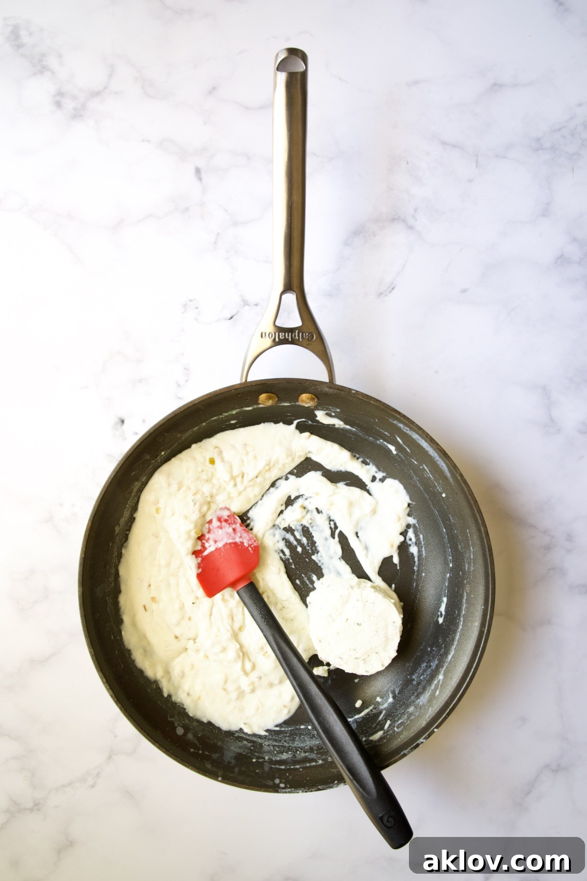 Thickened half-and-half in a nonstick skillet with Boursin cheese added.
