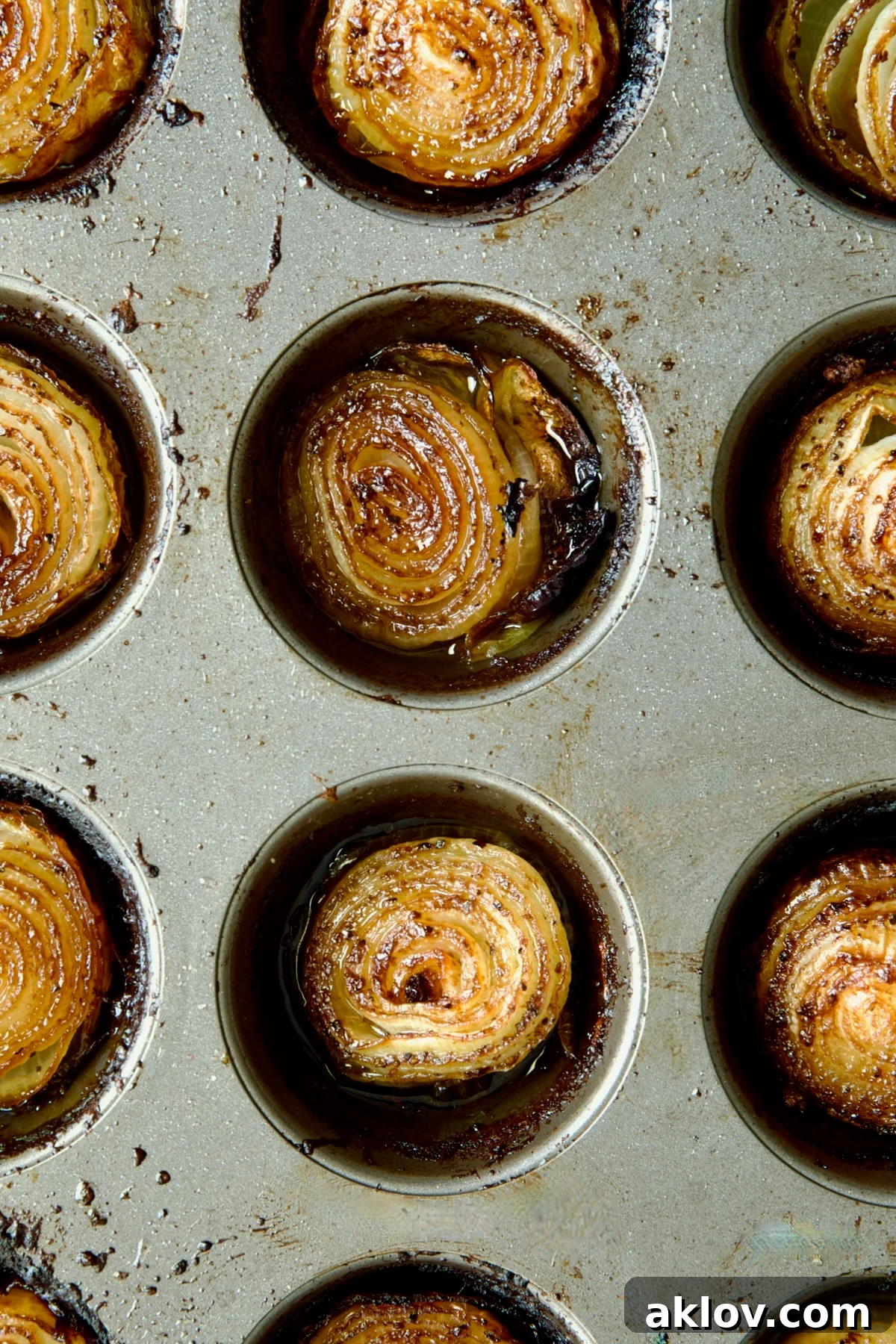 Close-up of a beautifully roasted onion half, displaying its rich golden-brown color and tender, layered texture.