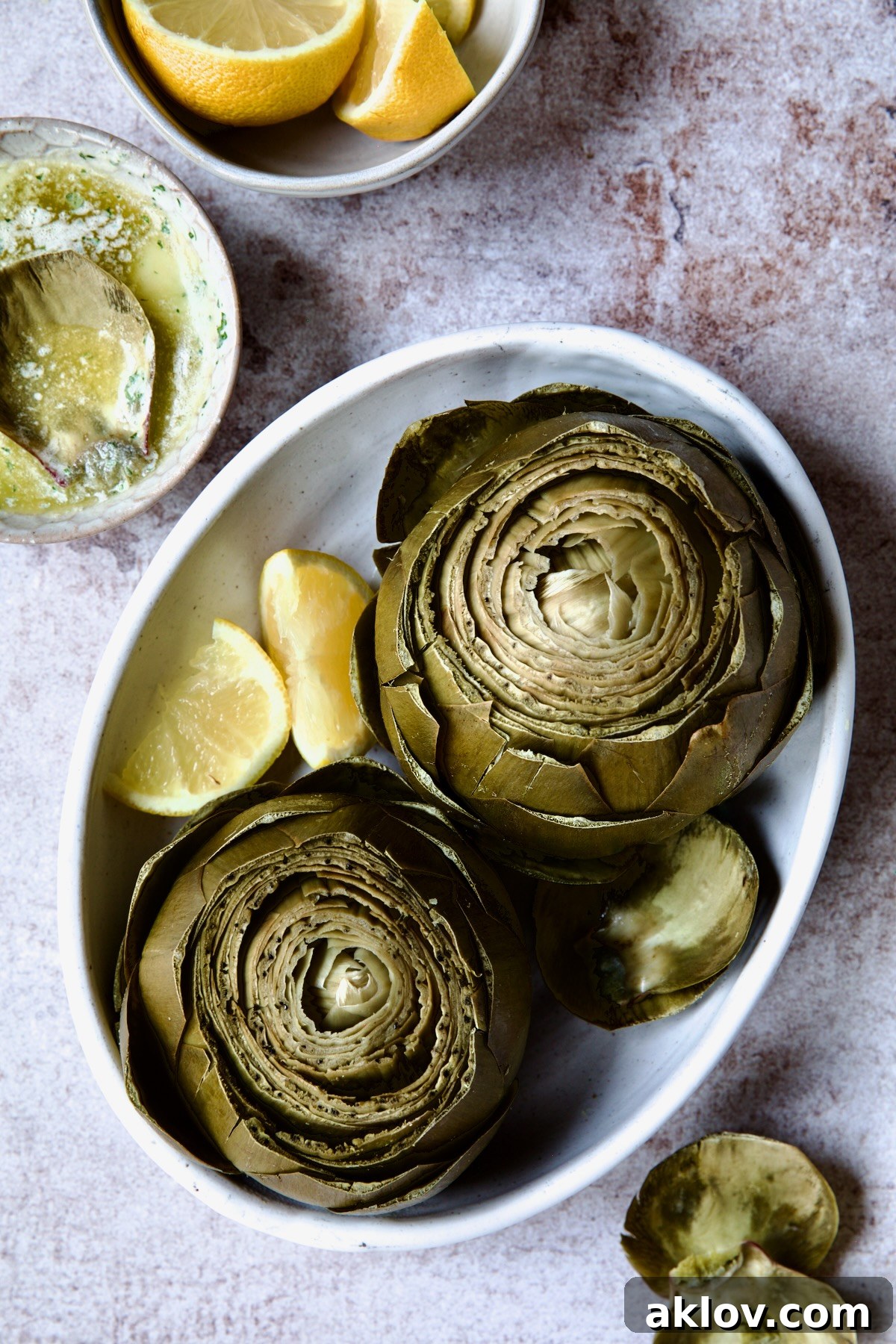 A vibrant close-up of tender Instant Pot Artichokes, perfectly steamed and presented with bright lemon wedges, ready for enjoyment.