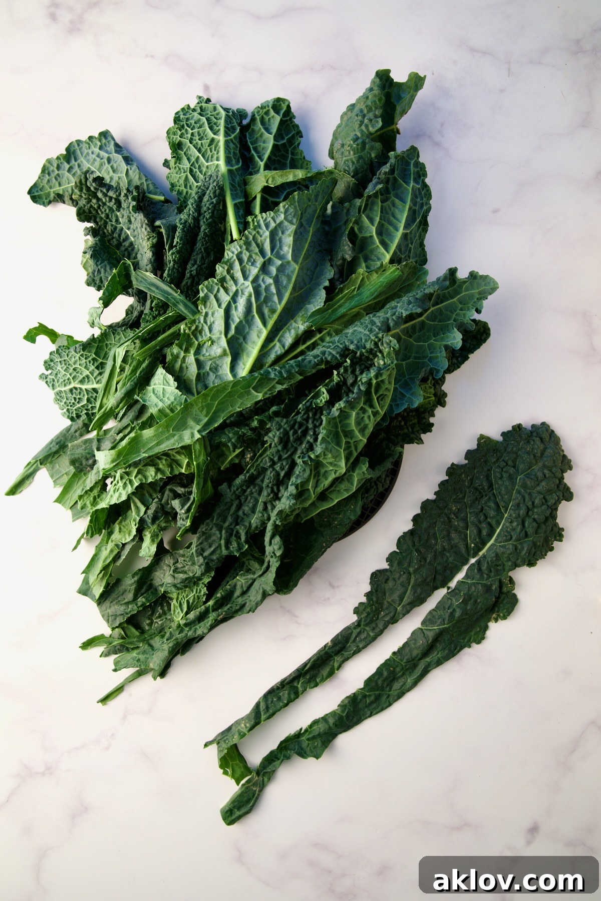 Clean Lacinato kale leaves with their tough stems expertly removed, ready for chopping.