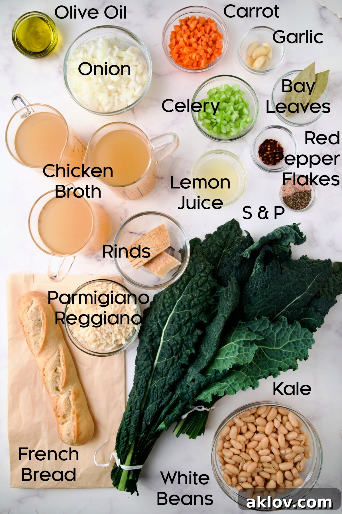 A selection of fresh ingredients neatly arranged in glass bowls, including chopped onions, carrots, celery, vibrant green kale, and canned white beans, ready for making White Bean Kale Soup.