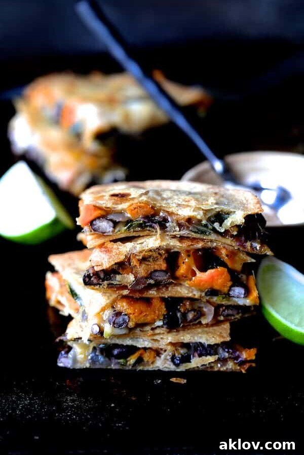 Stack of four Sheet Pan Sweet Potato, Poblano and Black Bean Quesadillas wedges.