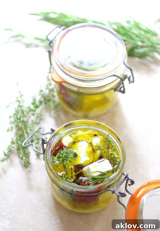 Photo of marinated feta cheese in glass jars.