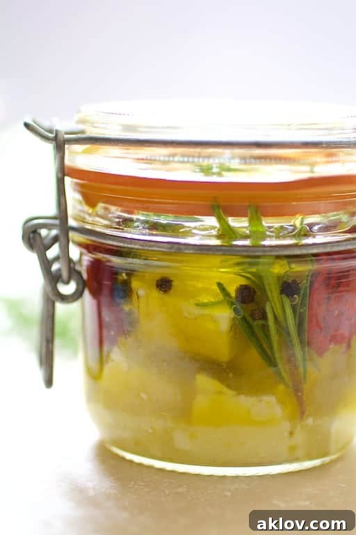 Close-up photo of a jar of marinated feta cheese.
