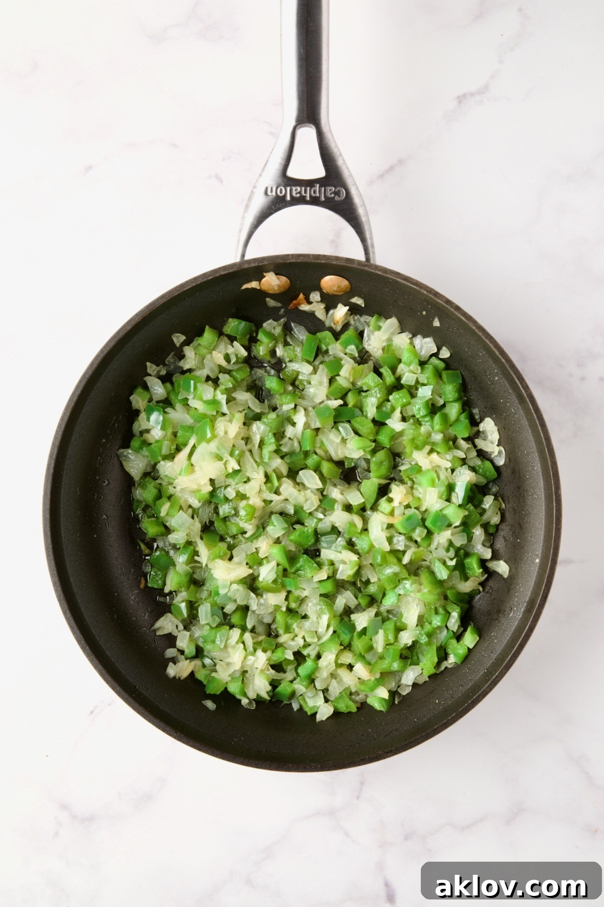 Cooked onions and green peppers in a nonstick skillet.