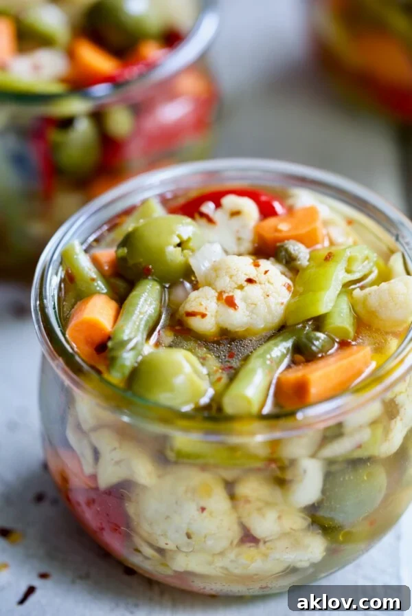 Finished Giardiniera (Italian Pickled Vegetables) in a glass jar.