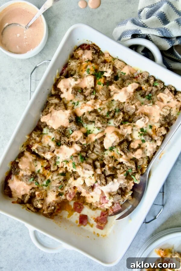 Reuben Casserole in white rectangular baking dish on cooling rack, a convenient and hearty twist on the classic sandwich.